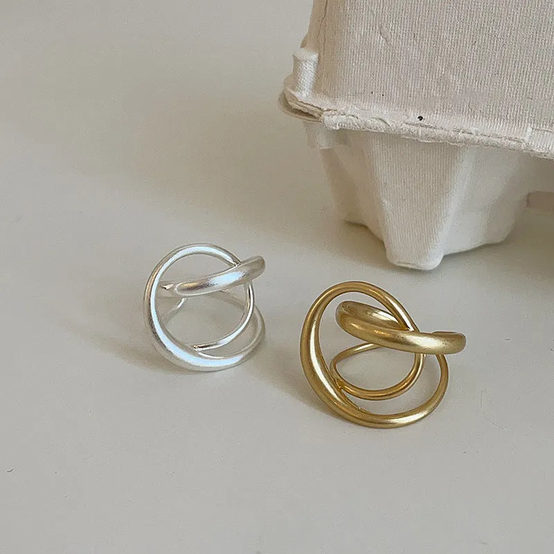 Geometric open ring with interlaced matte metal design in gold or silver electroplated finish