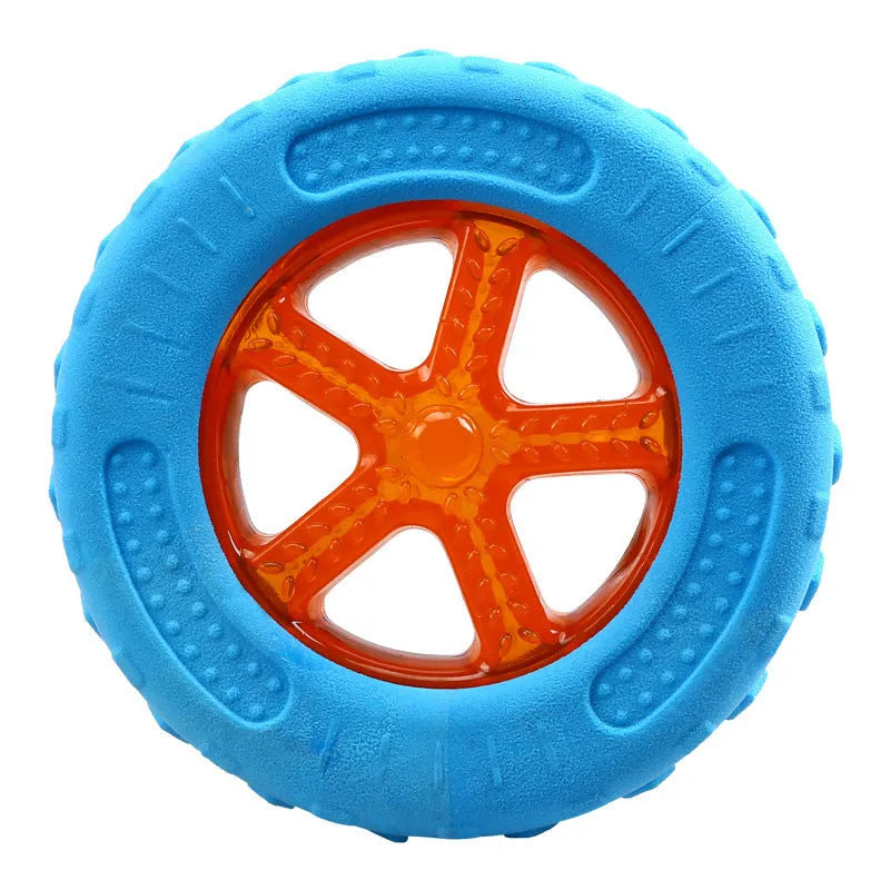 Set of three TPR dog toys: a blue squeaky ball, an orange barbell, and red tyres on grass.