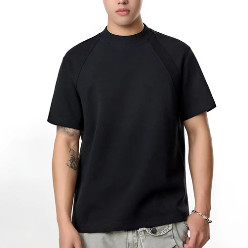 Man wearing a loose-fit grey short sleeve polyester top with air layer stitching.