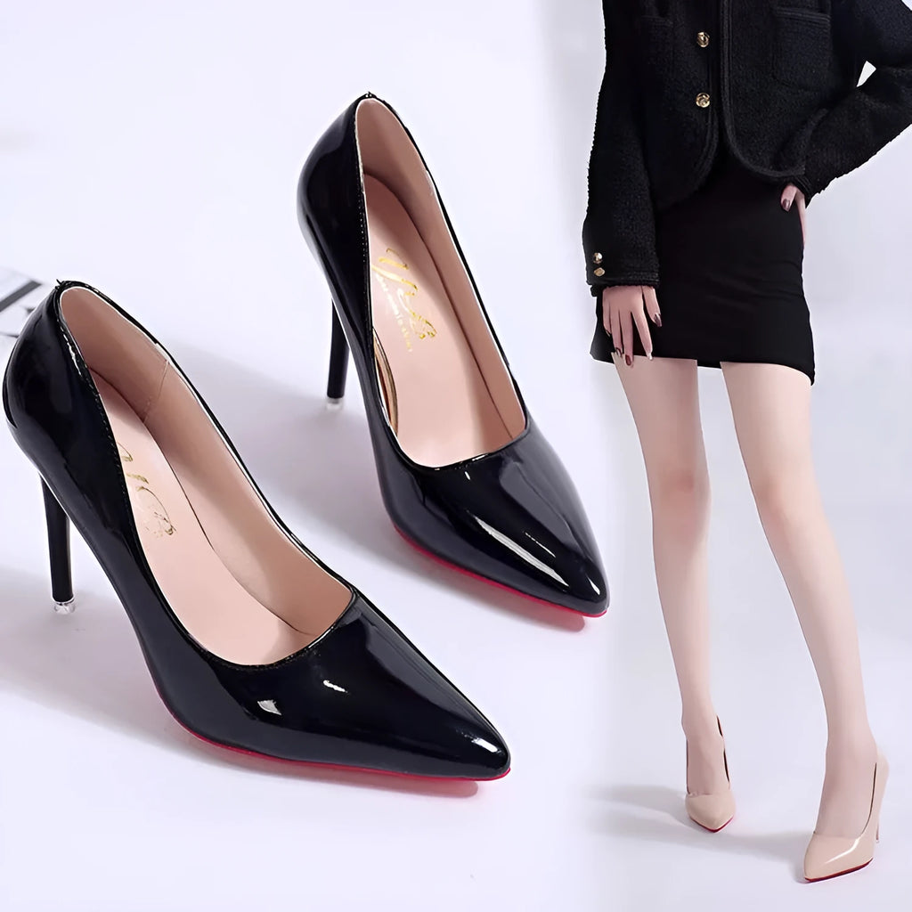 Women's black pointed toe stiletto pumps with a low-cut vamp and thin high heel on a white background.