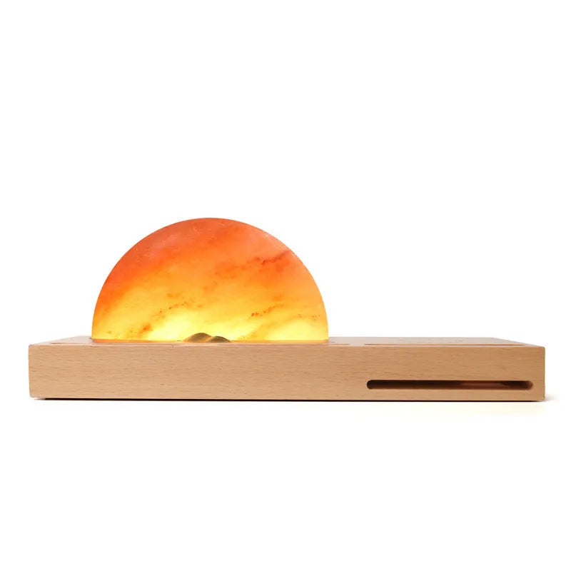 Natural crystal salt lamp with solid beech wood base and integrated Qi wireless phone charging pad.