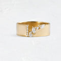 Gold-plated copper ring with shining zircon stones on a white background