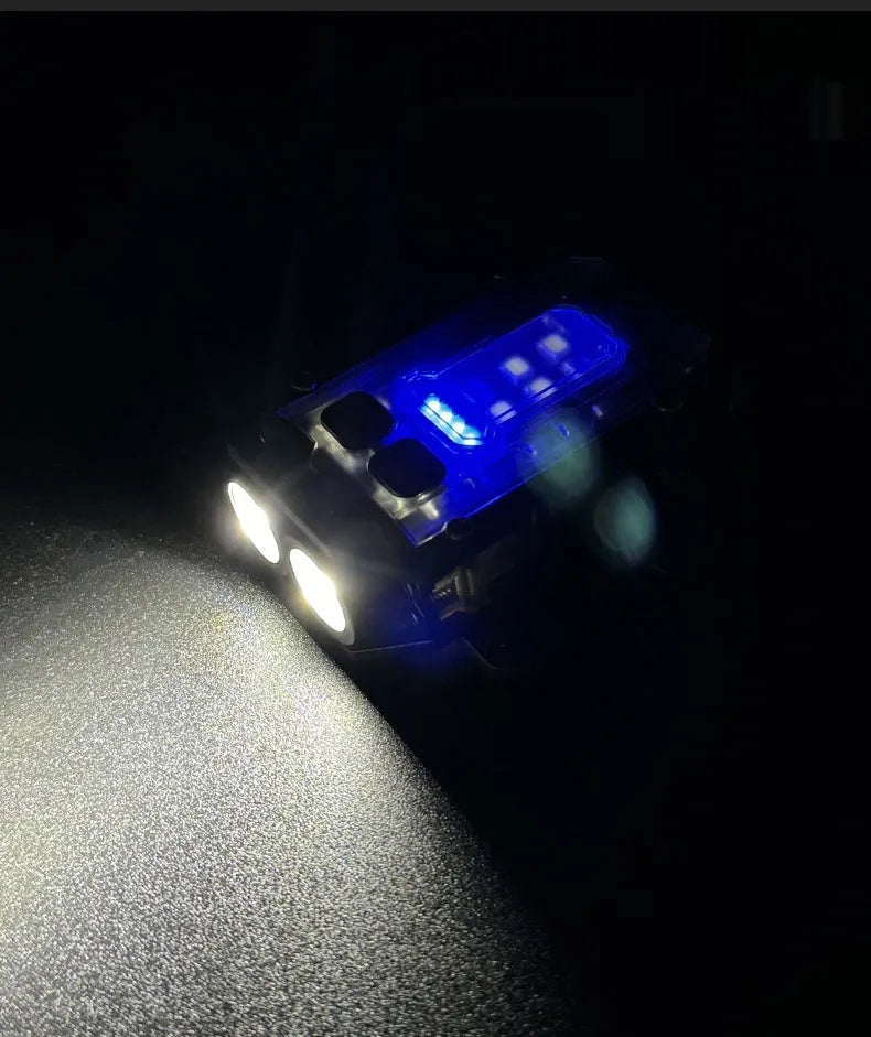 Portable mini tactical warning flashlight with USB charging cable on a backpack strap.