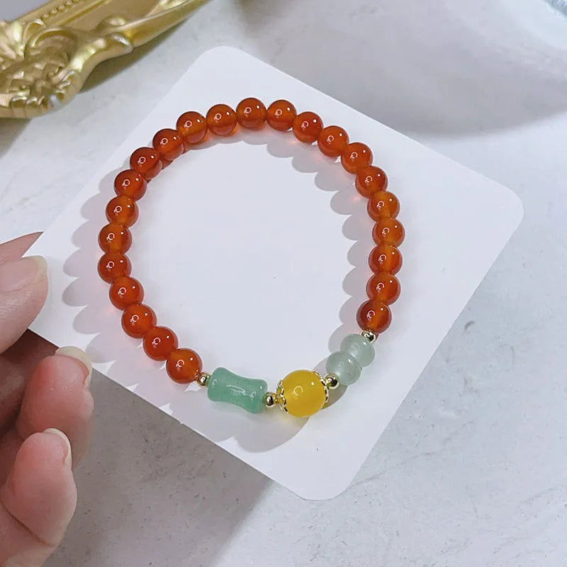 Handmade red agate bracelet with dragon and lucky bag Chinese designs for women.