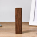 Brown walnut wood portable power bank showing its rectangular shape and natural wood grain.