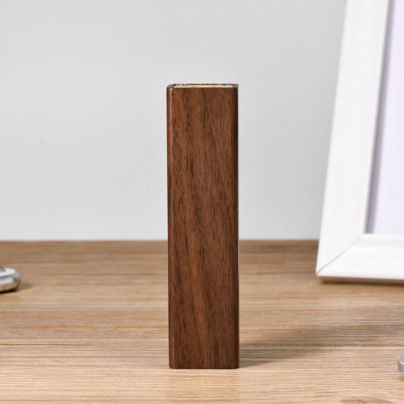 Brown walnut wood portable power bank showing its rectangular shape and natural wood grain.
