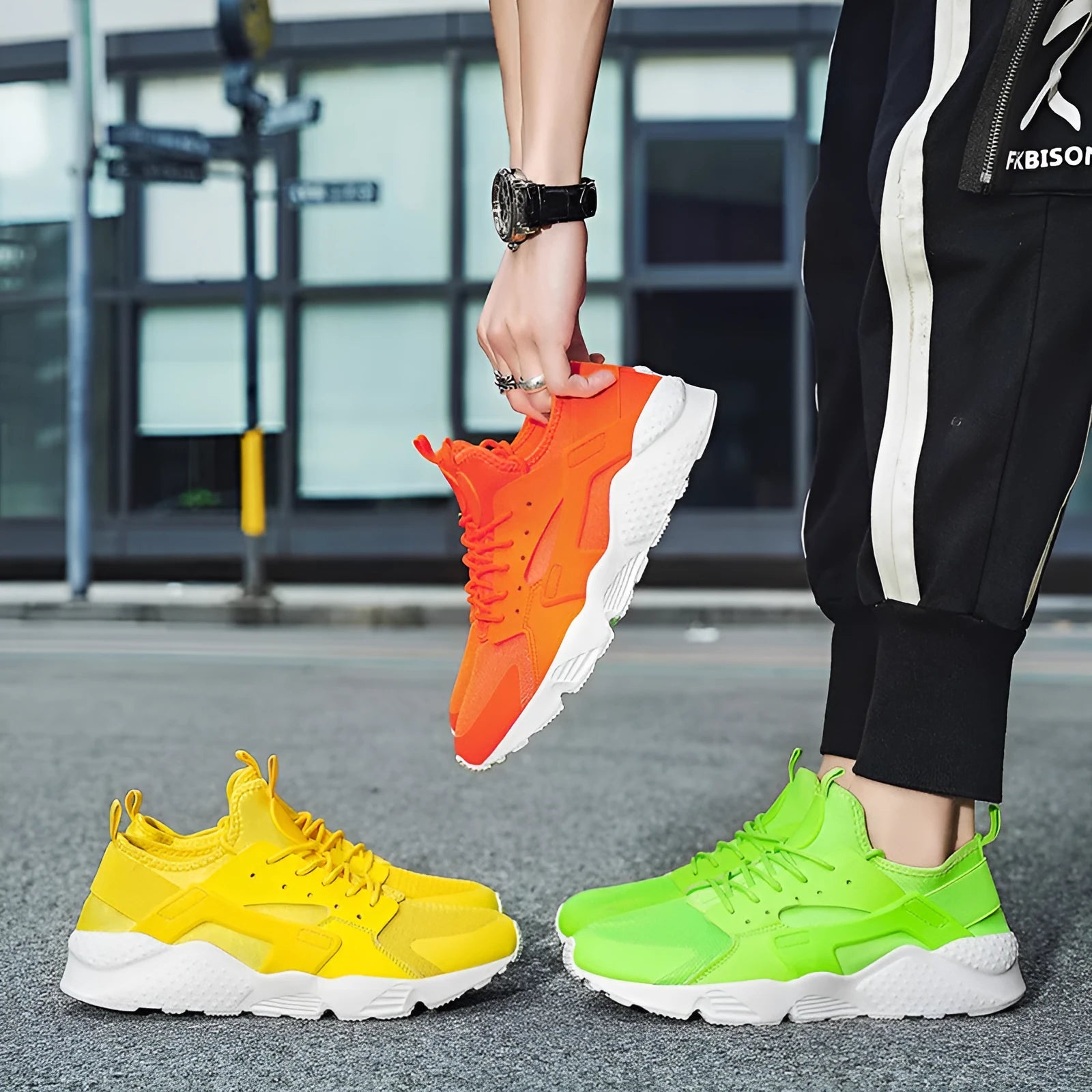 Men's green low top mesh casual shoes with lace-up front and cross straps on a flat sole.
