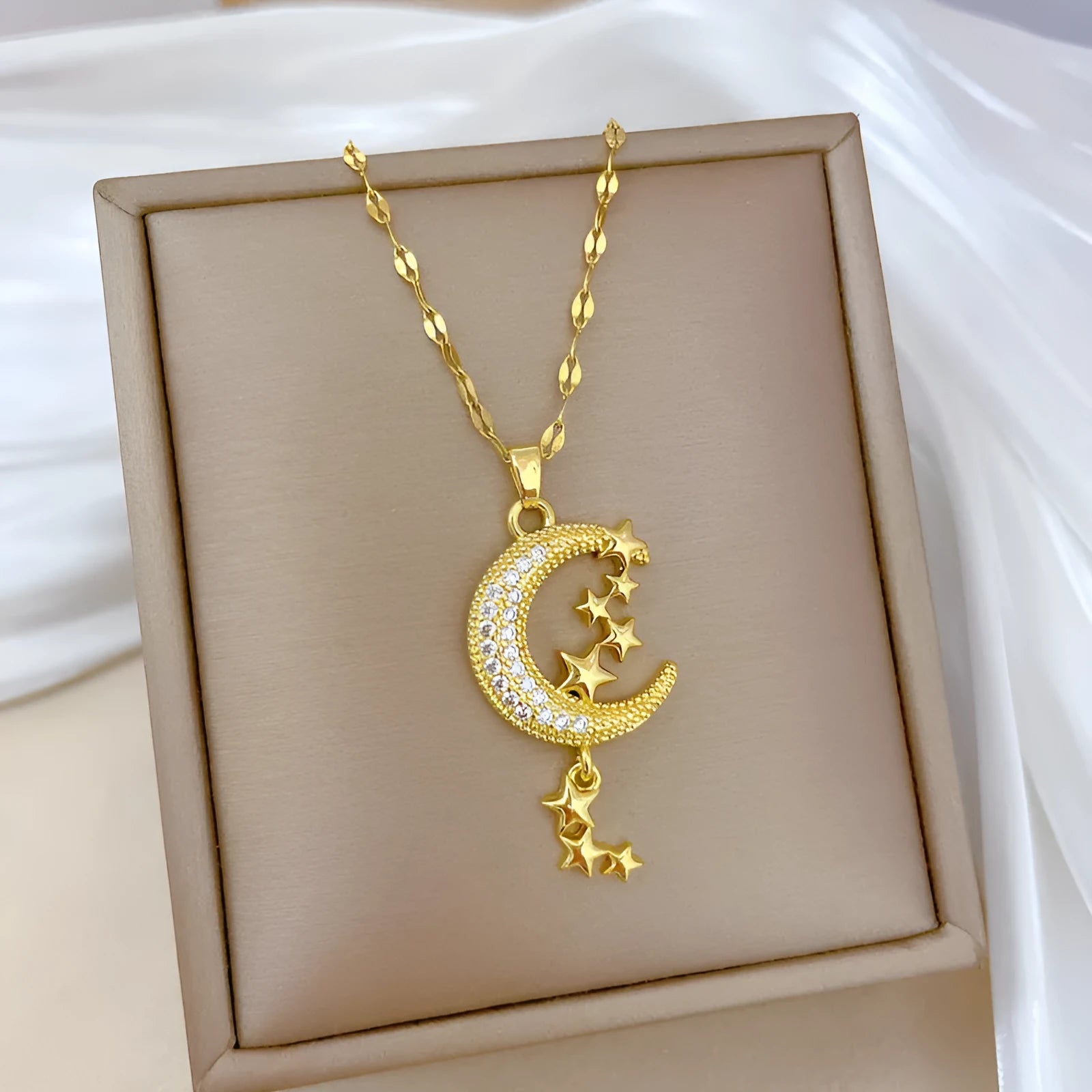 Silver tone necklace with moon-shaped copper pendant on stainless steel chain