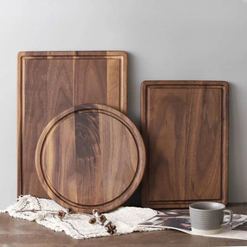 Black walnut wood cutting board with juice groove and side handle shown in three size options