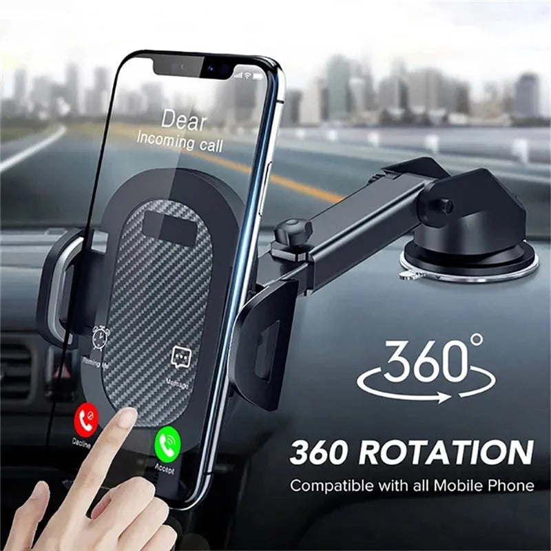 Black universal car phone holder mounted on a dashboard, showing a smartphone secured in the cradle.