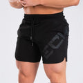Men's black knee-length running shorts with elastic waist, shown flat for detail.