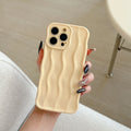 iPhone 17 Pro Max in a silver electroplated TPU case with a textured wave stripe pattern on the back.