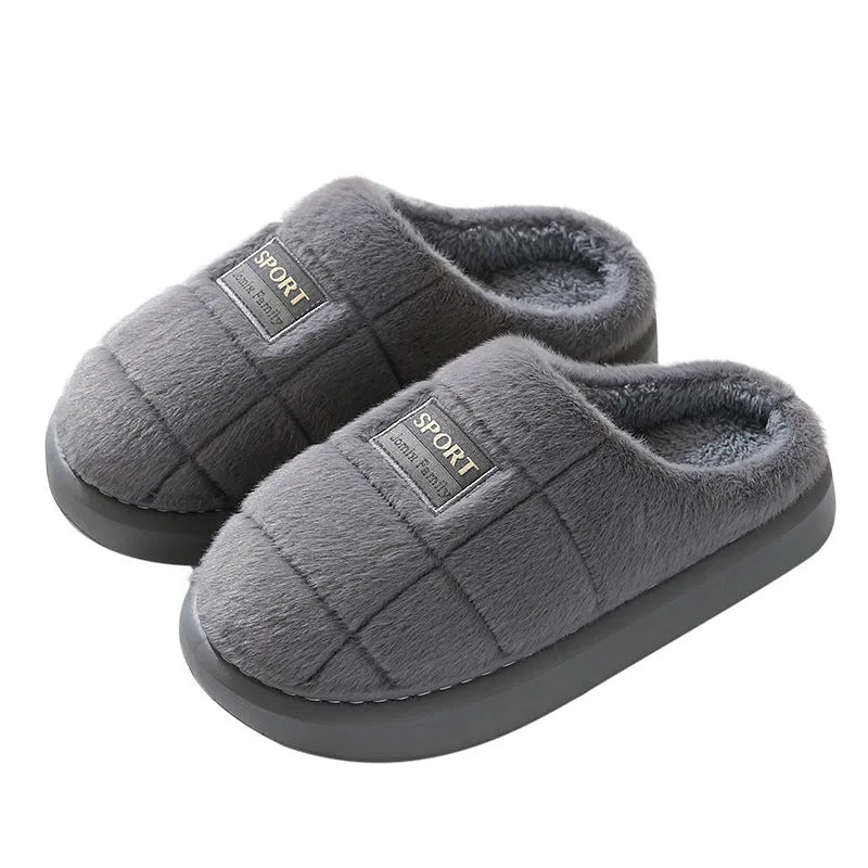 Men's grey plaid rabbit hair slippers with a thick sole, shown on a wooden floor.