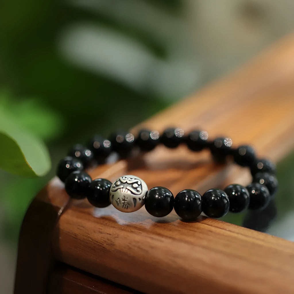 Black agate bracelet with 10mm beads and sterling silver clasp on wrist
