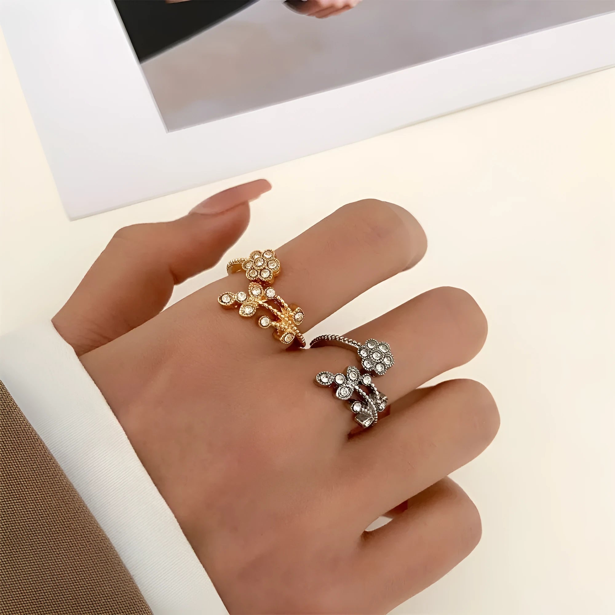 Gold and white women's open ring with floral leaf design and diamond treatment.