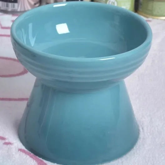 Black ceramic pet bowl with high foot and raised neck for dog or cat feeding
