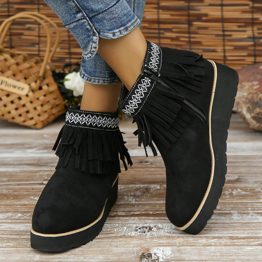 Women's dark brown suede ankle boot with wedge heel, side zipper, and decorative tassel.