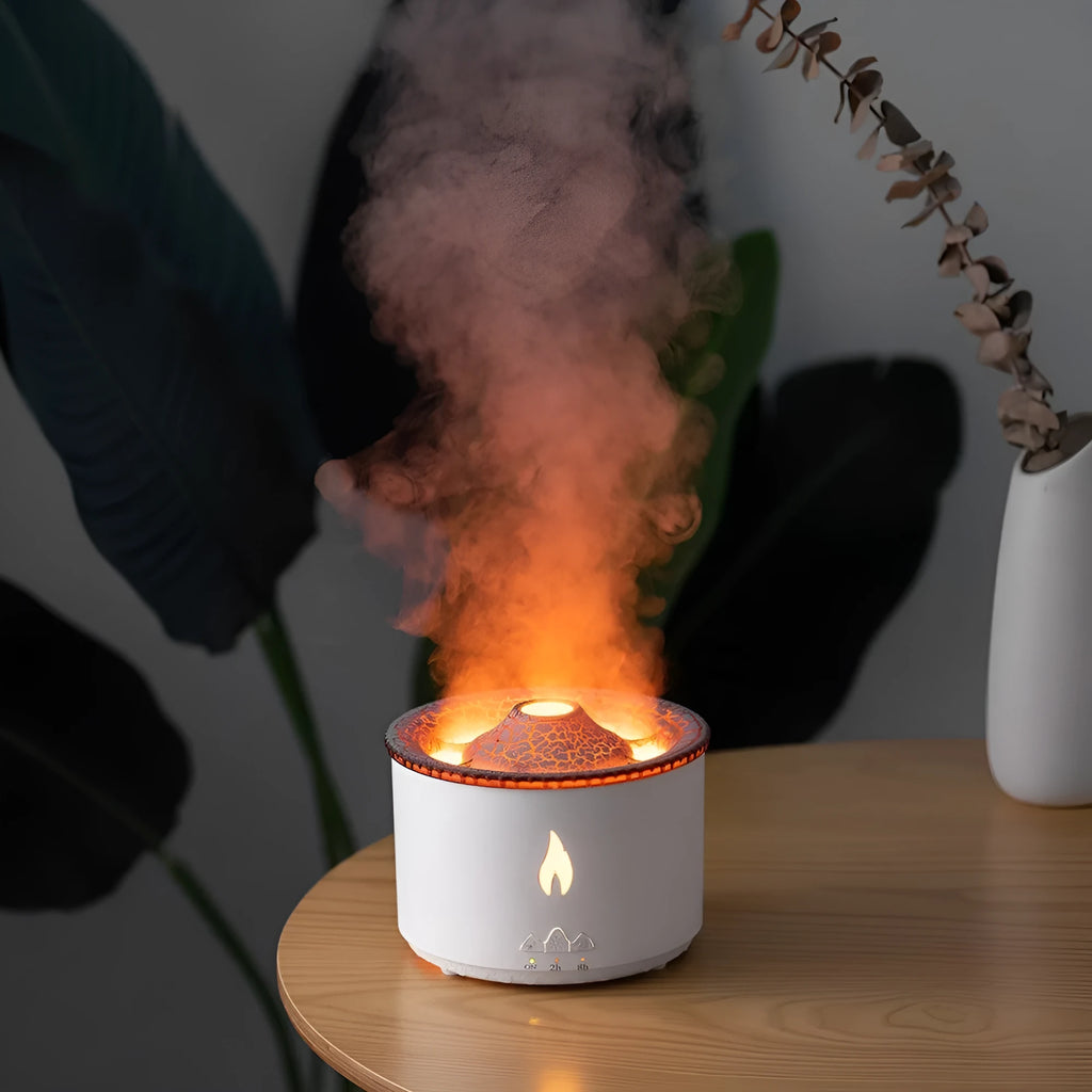 Round two-colour flame spray mist humidifier and aromatherapy diffuser on a table.
