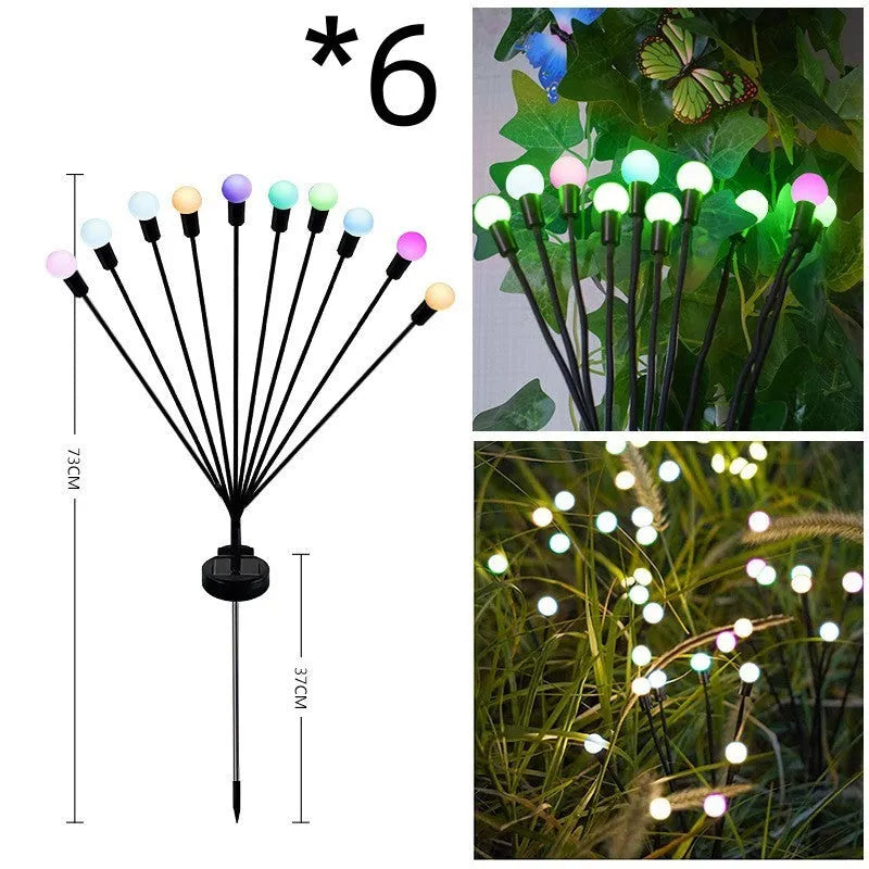 Solar-powered LED firefly lawn light with ground stake inserted in grass