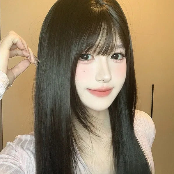 Dark brown long straight synthetic wig with a full fringe on a wig head.