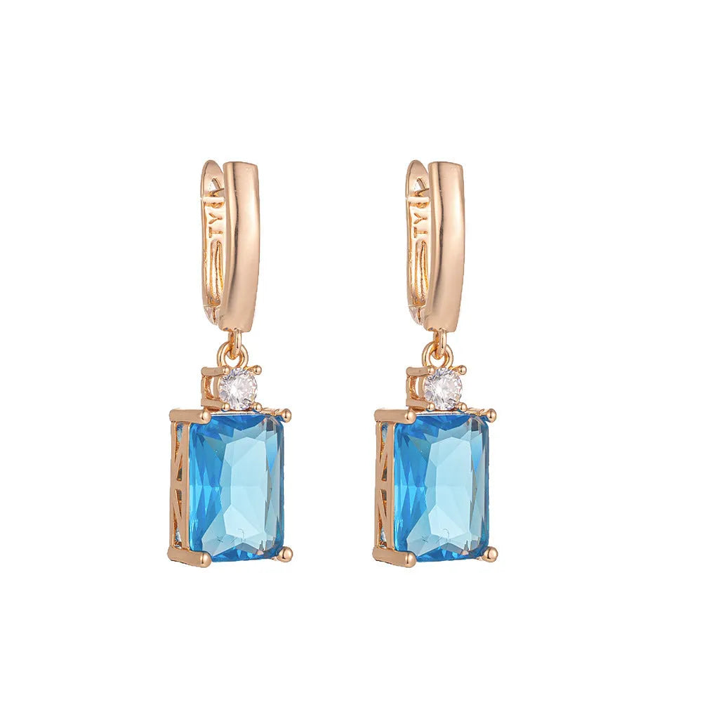 A pair of square geometric earrings with a quadrilateral design in a gold or silver electroplated finish.