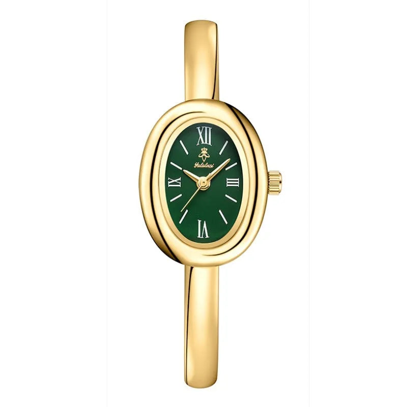 Women's slim oval retro quartz watch in gold colour on wrist