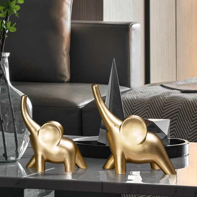 Minimalist rose gold and white resin elephant ornaments on a shelf, showing large and small sizes.
