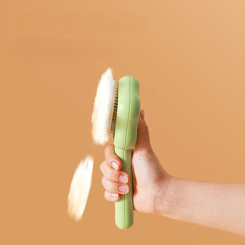 Self-cleaning stainless steel cat comb magic wand measuring 20cm with green or yellow colour options