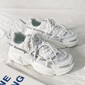 Men's white platform dad sneakers with lace-up front and chunky sole for height increase.