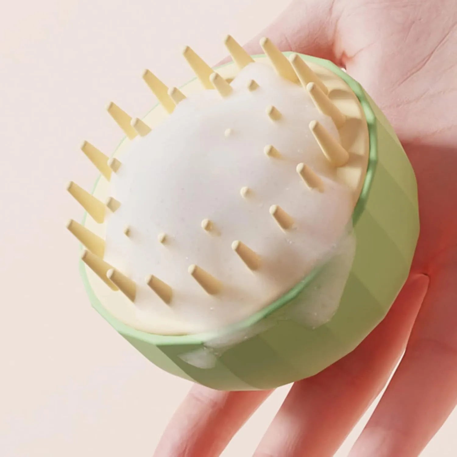 Green silicone pet bathing brush with massage bristles for dogs and cats during shampoo application