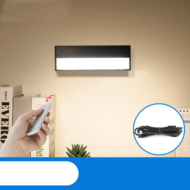 White and black portable magnetic LED desk lamp with adjustable dimming on a wooden desk