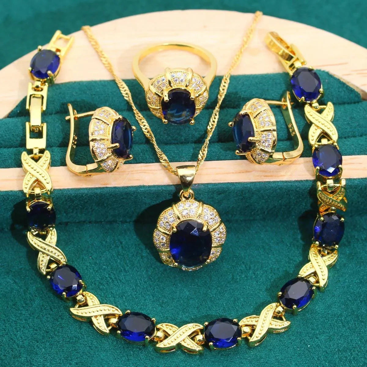 18k gold plated jewellery set showing necklace, earrings, ring and bracelet with coloured cubic zirconia stones.