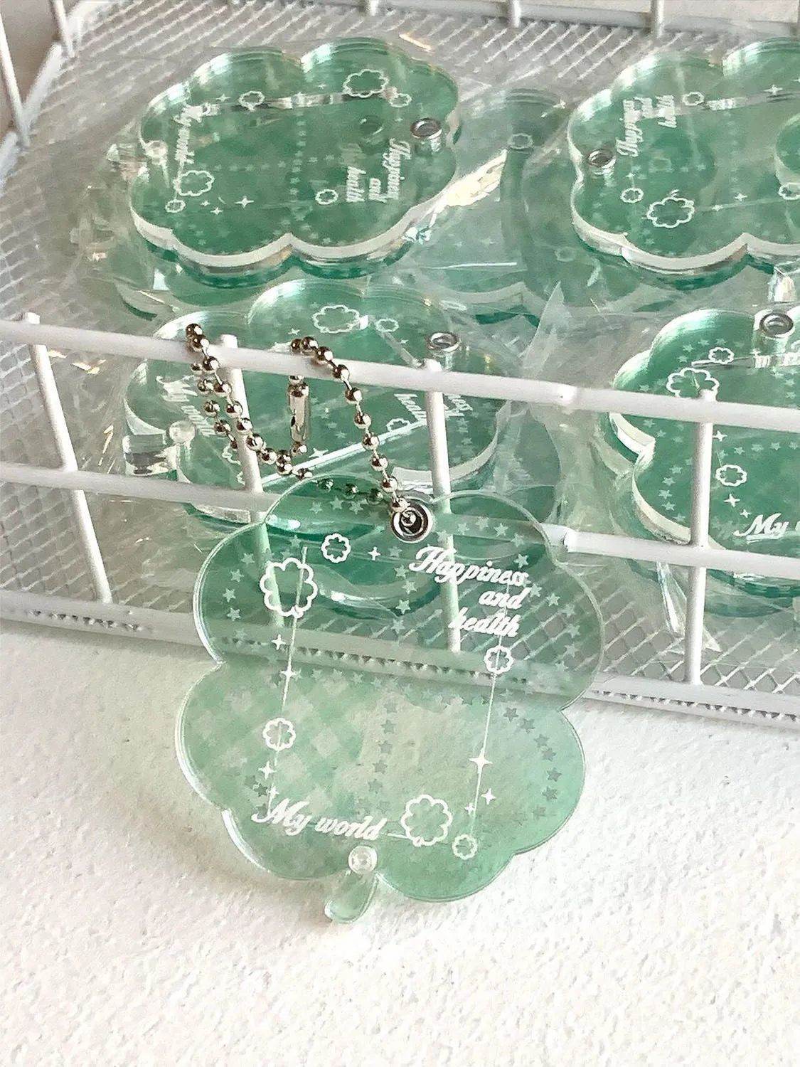 Acrylic four-leaf clover mobile phone pendant keychain in blue, green, and mint colours