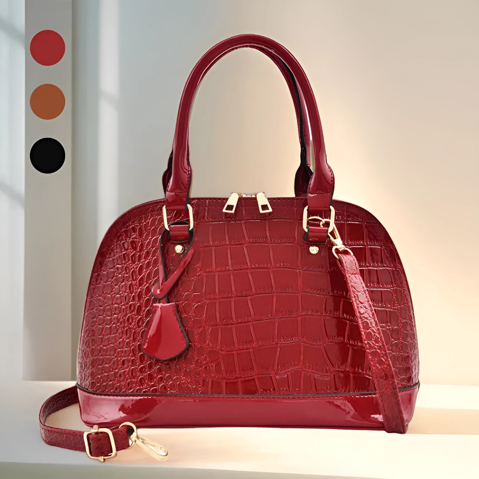 Shiny black PU crossbody bag with a structured shell shape and an adjustable strap.