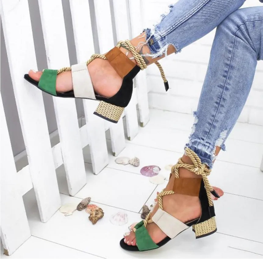 Women's beige suede sandals with fish-mouth toe, colour-matched pattern, and ankle strap on a thick heel.