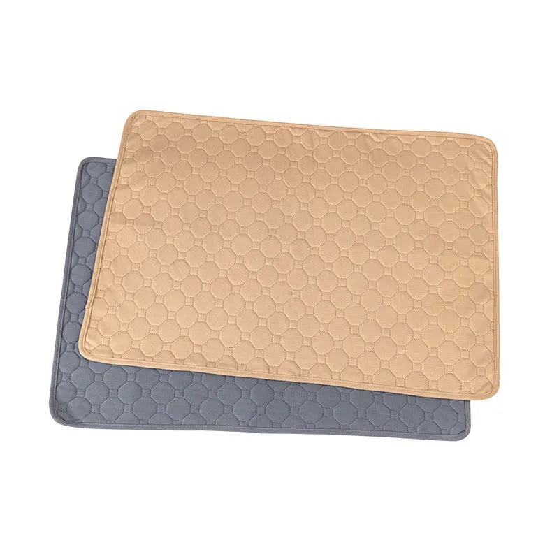 Pet Parents grey and khaki washable dog pee pads in multiple sizes on a wooden floor.