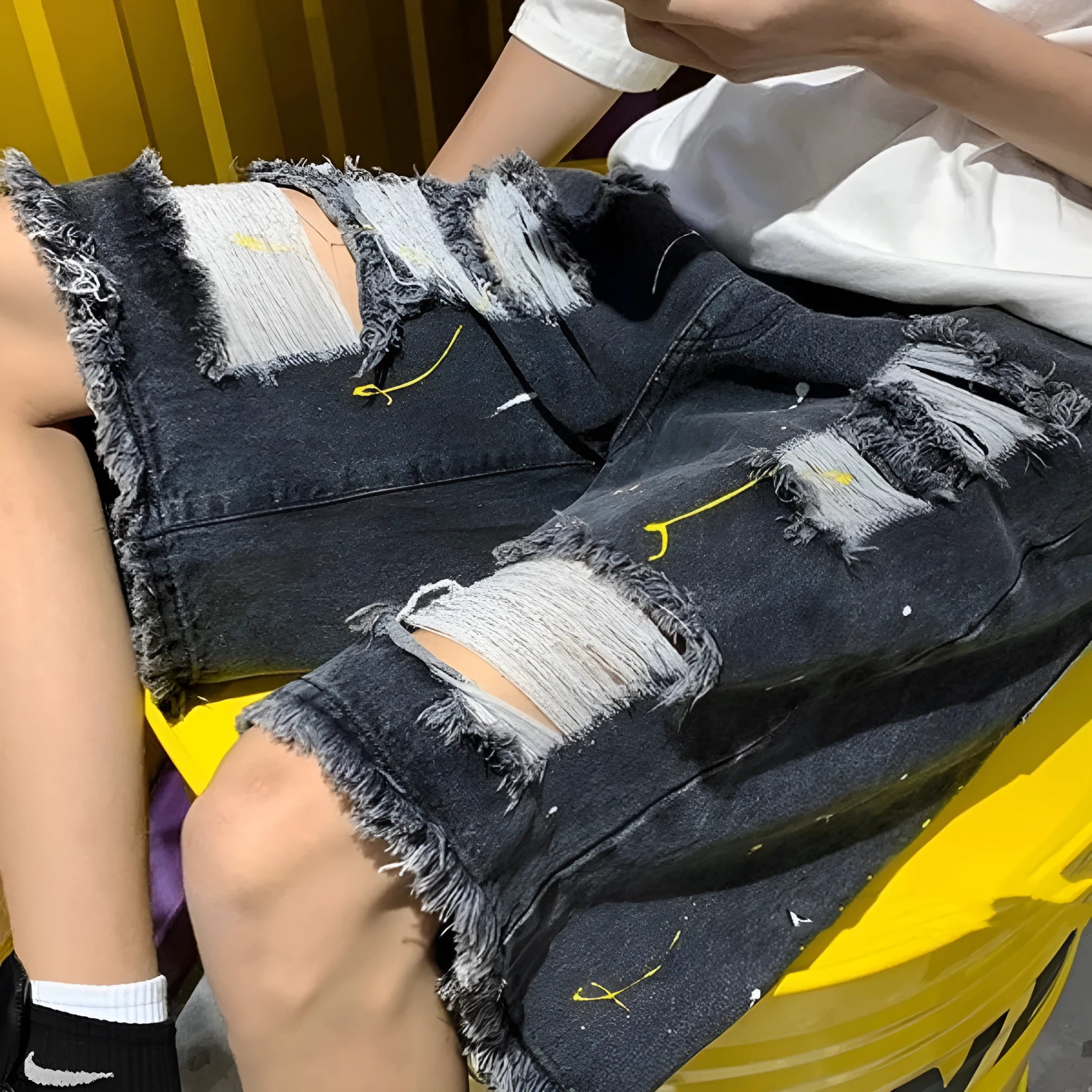 Men's black and light blue loose-fit water-washed denim shorts on a size chart.