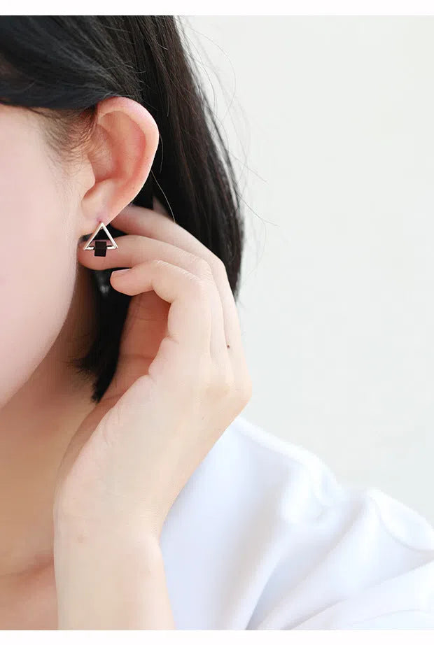 Sterling silver S925 geometric triangle black earrings with gem inlay on neutral background