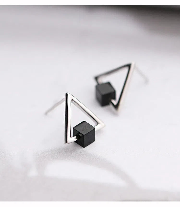 Sterling silver S925 geometric triangle black earrings with gem inlay on neutral background