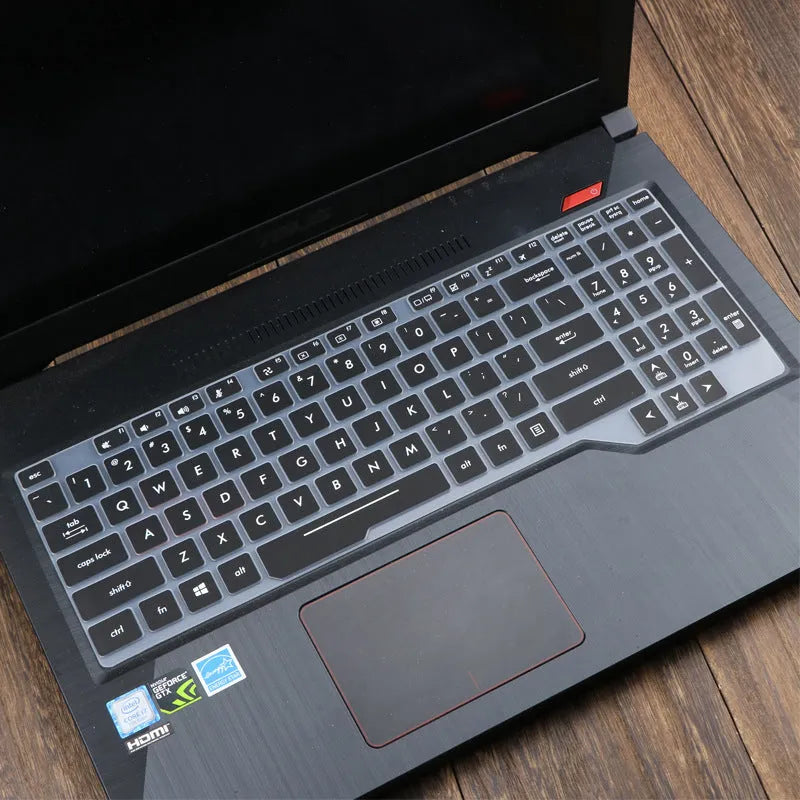 Clear protective keyboard film cover for ASUS Flight 14-inch laptop on a keyboard.