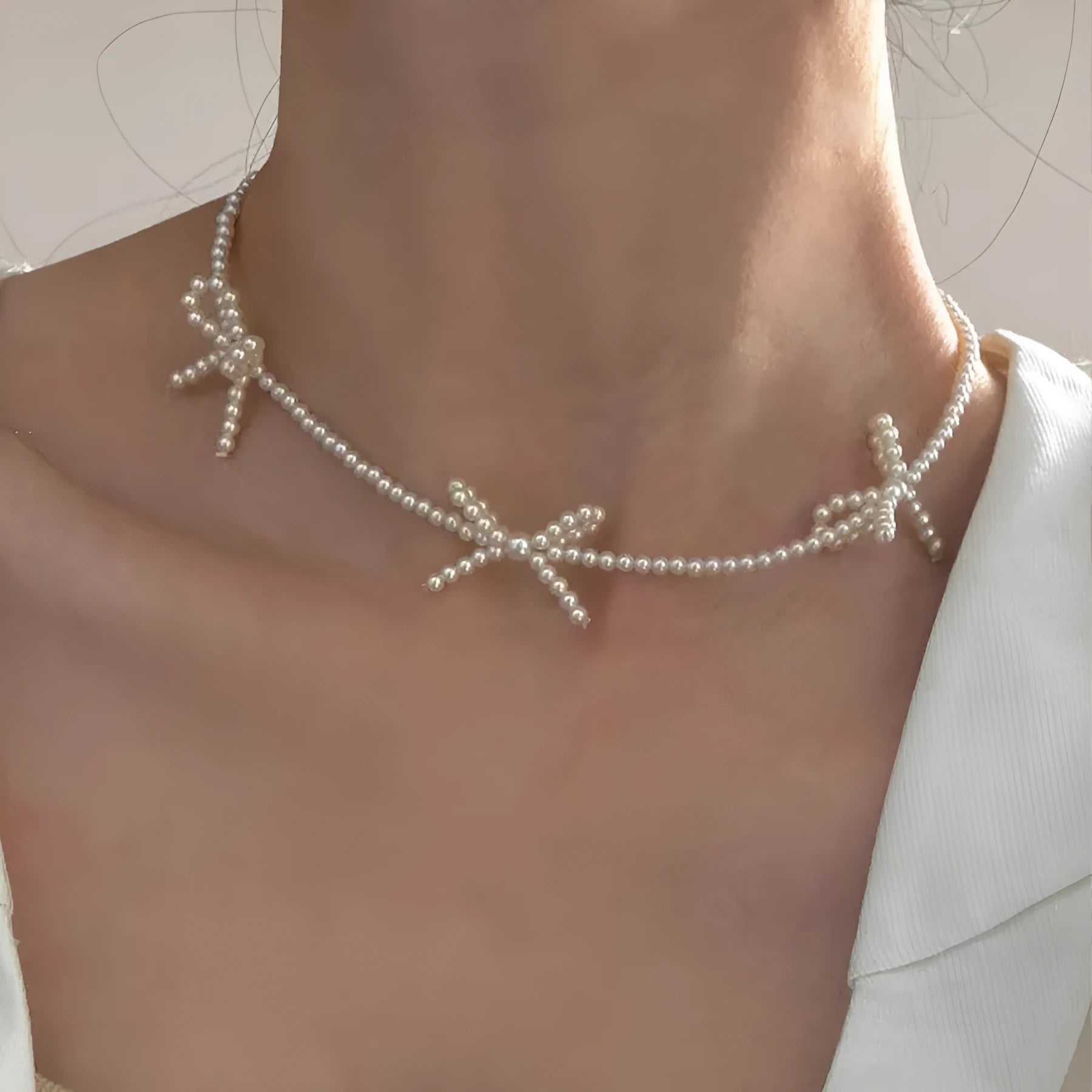 White sweet bow pearl necklace for women on an adjustable 31cm-40cm chain.