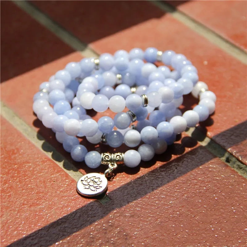 Vintage natural stone bracelet for women with a geometric lotus pendant on a model's wrist.