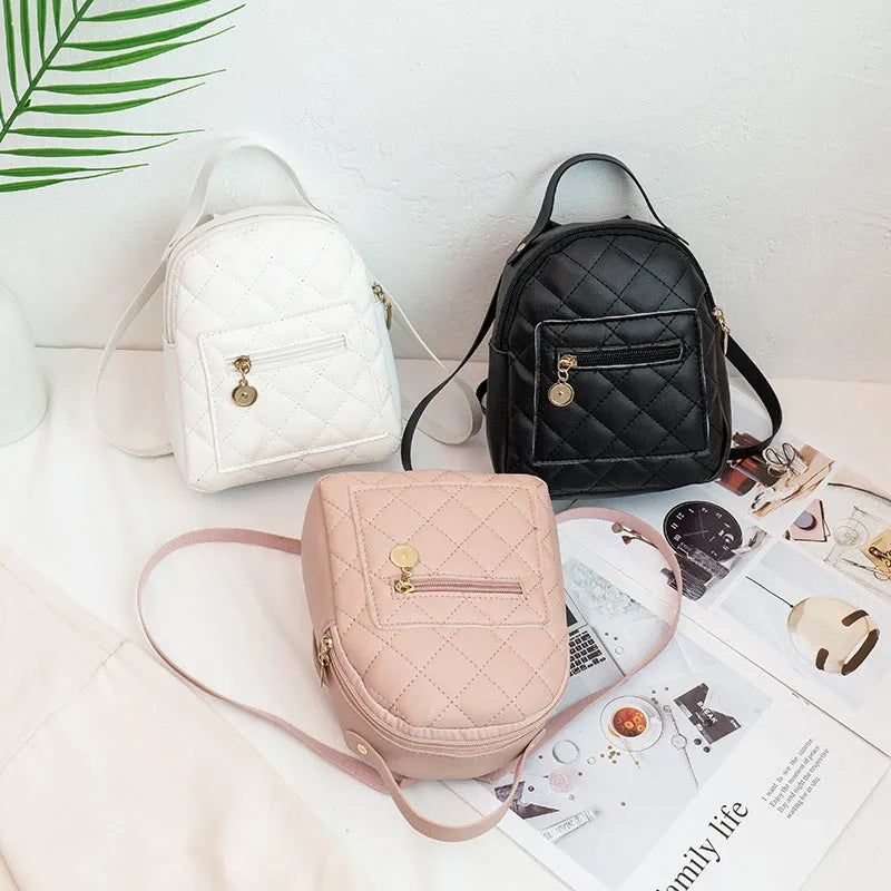Girls' hard case Korean-style embroidered backpack in pink showing vertical square shape and soft carry handle.