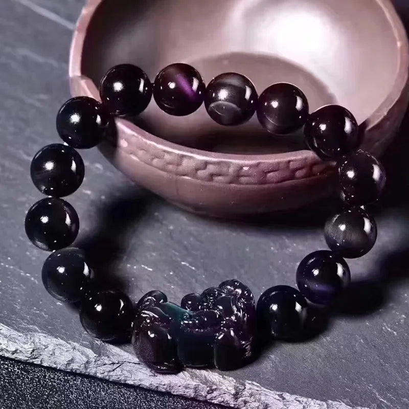 Natural ice colour Eye Obsidian crystal bracelet showing semi-translucent beads on wrist