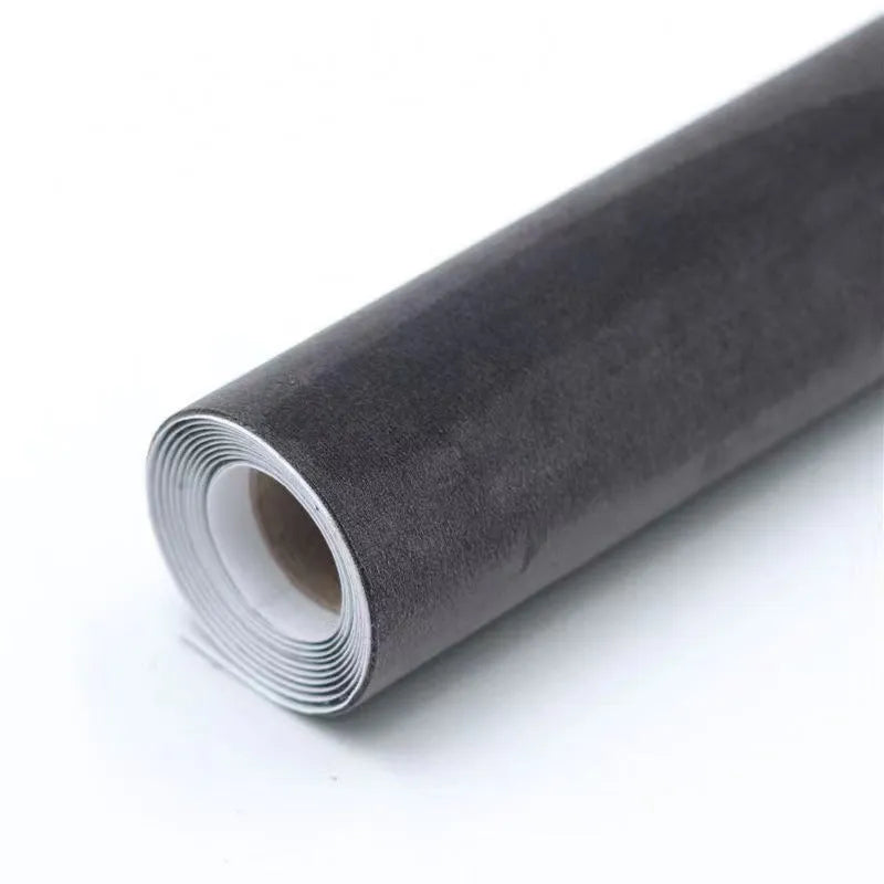 A sheet of self-adhesive black leather suede material with a ruler showing its 0.5mm thickness.