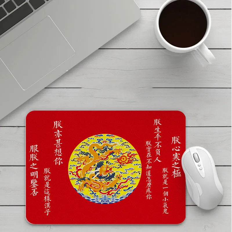 Custom cartoon design on a small black thickened mouse pad with stitching, shown on a desk.