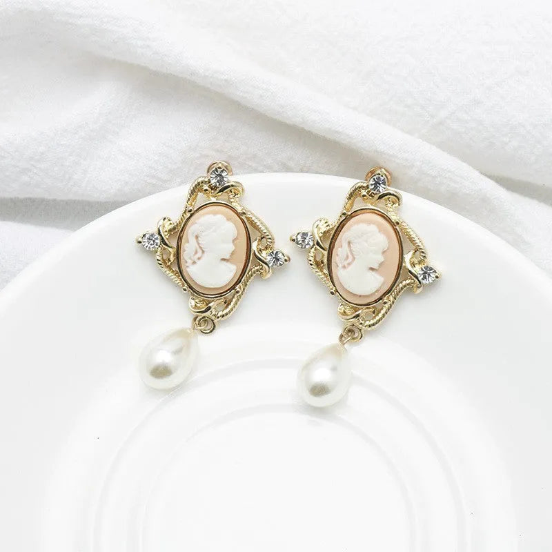 Gold alloy retro embossed geometric earrings on a surface