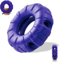 Blue, green, and red tyre-shaped dog chew toy with oval openings, a slow feeder and treat dispenser.