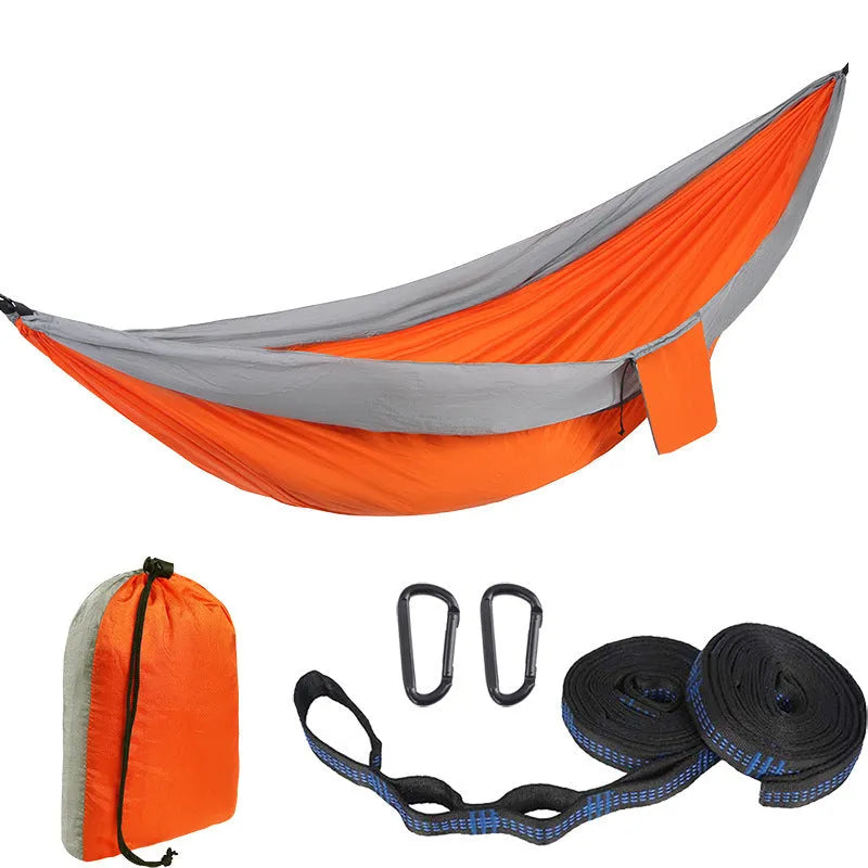 Double camping hammock with ropes and buckles shown in outdoor setting
