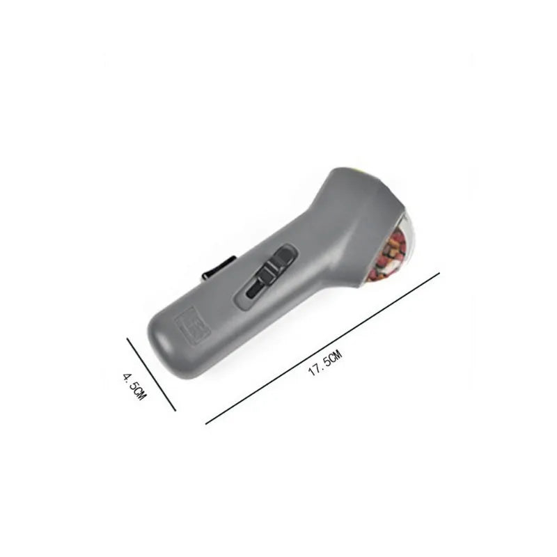 Grey pet snack catapult launcher for dogs and cats on a neutral background.
